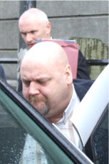 Brendan Henderson being helped into a car after the hearing. His solicitor Maoliosa Barr is in the background. 