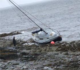 The yacht 'Nokomis' on the rocks in Lough Foyle.