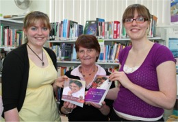 Emma and Simone McLaughlin present books on Amma to Carndonagh librarian Carmel Barron.