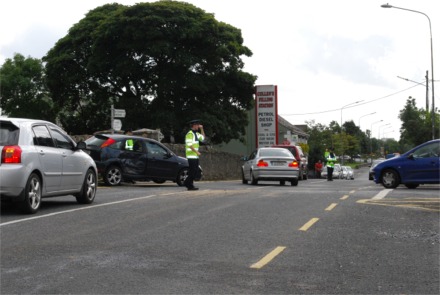 A Garda officer directs traffic following Saturday's accident between a lorry and car at Cockhill Bridge.