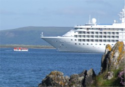 A tender returns to the ship with passengers.